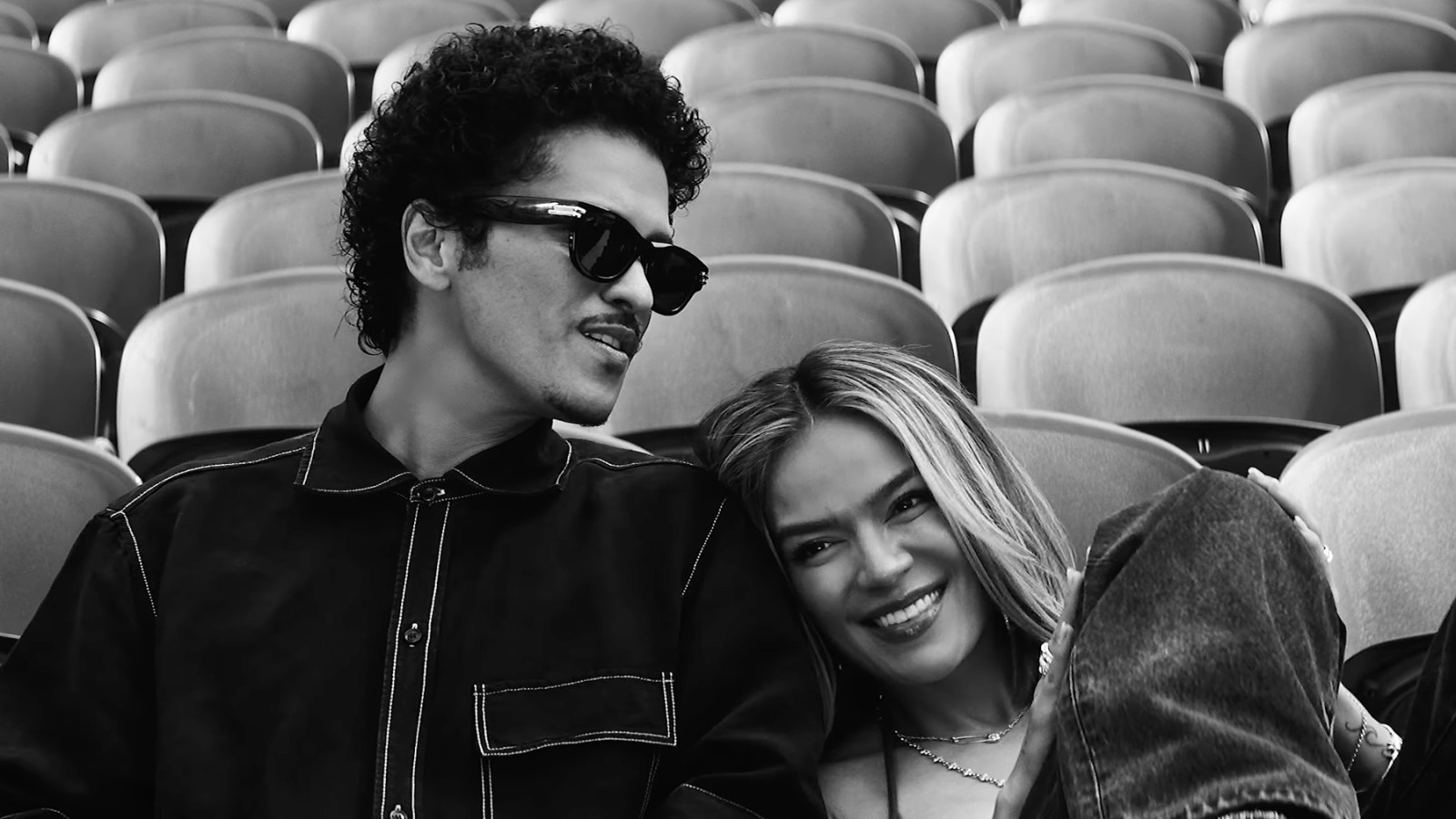 Karol G and Bruno Mars Fill a Stadium With Love in ‘Still’ Video